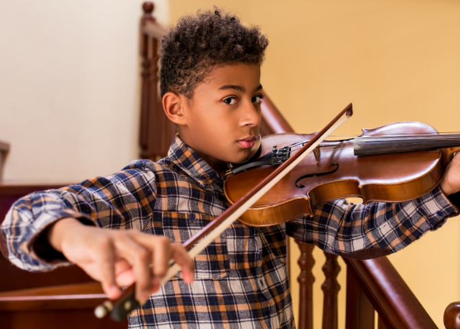 Black boy playing violin 